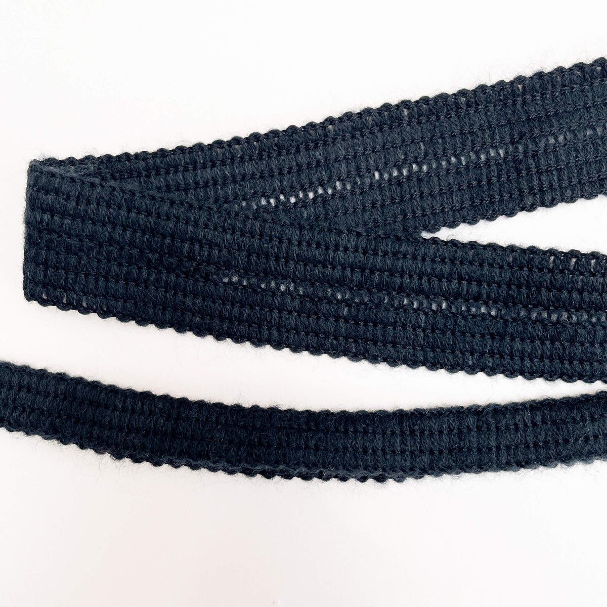 Close up of 17mm blue knitted binding tape, shown open and folded