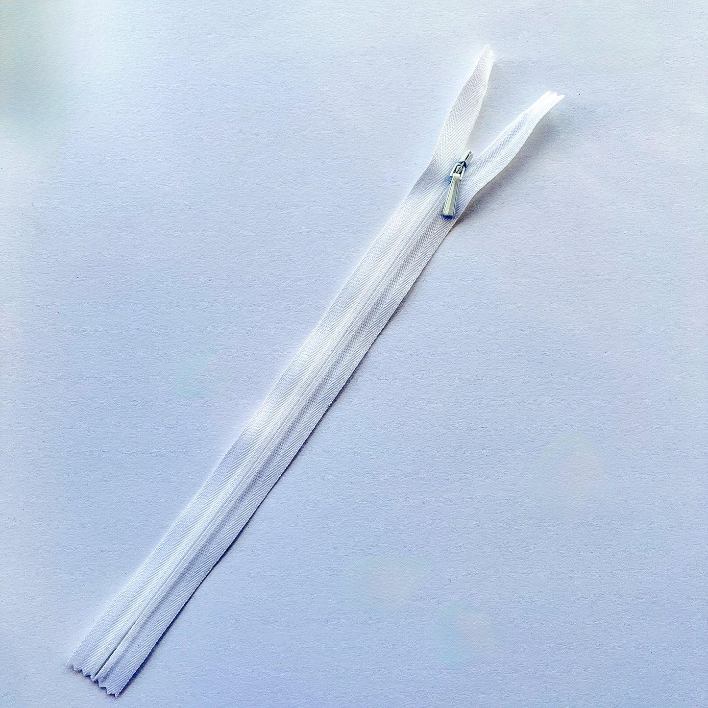 white zipper on a light gray background