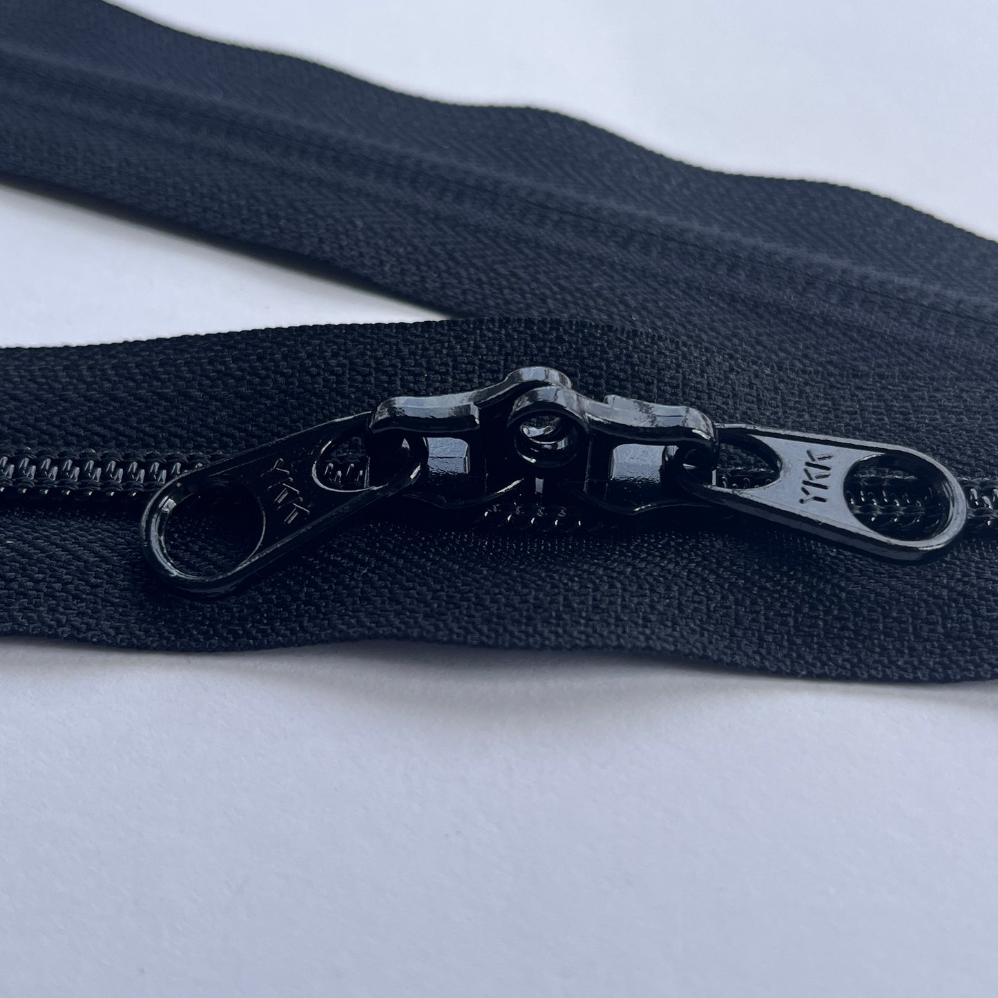 Black YKK head to head, 2 way closed end, coil bag zip with lockable pullers