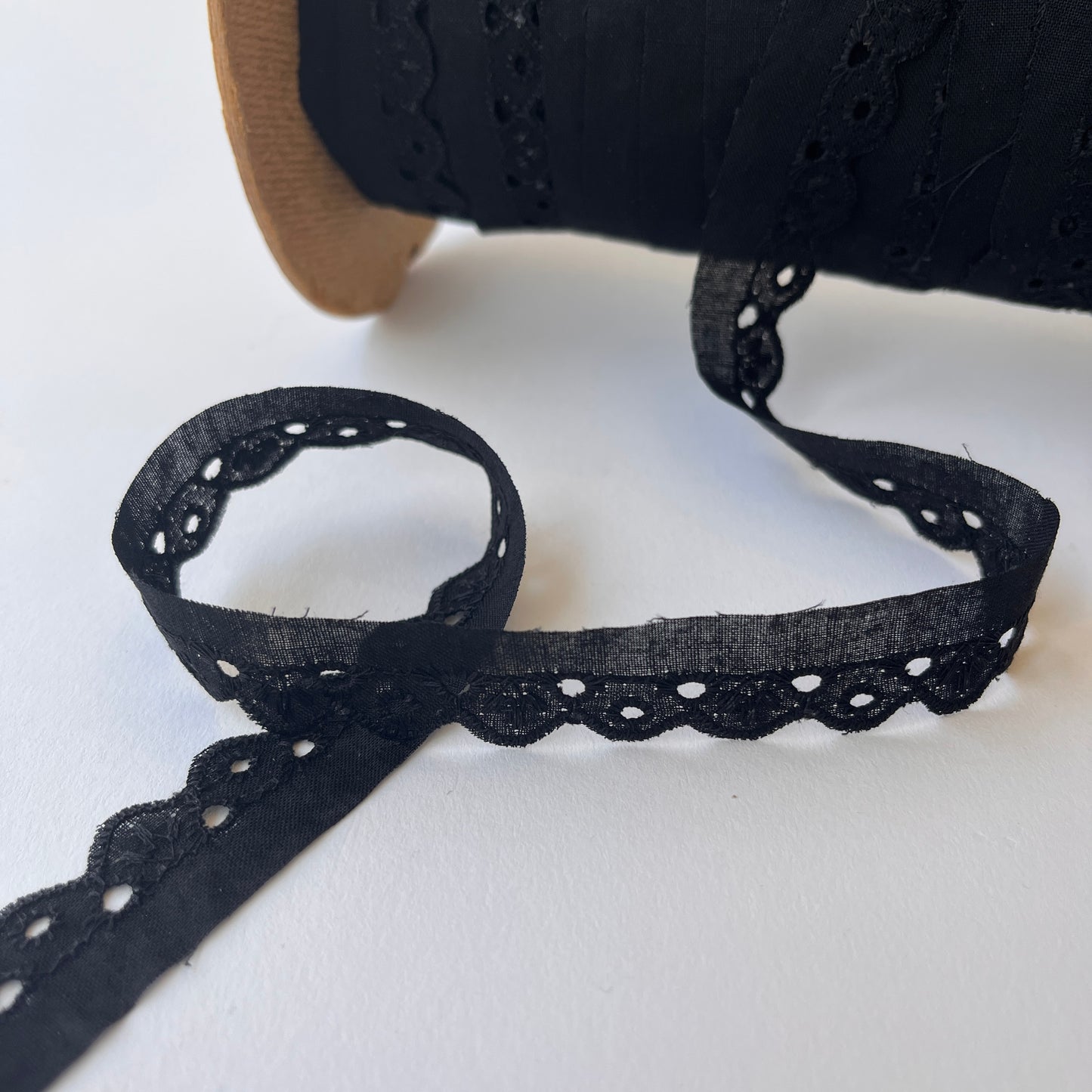 Narrow Broderie Anglaise cotton trim with scalloped edge in black. 2cm overall width / 1cm embroidered width , KLEINS HABERDASHERY. Choose our range of vintage lace, trims & sewing accoutrement rescued from a London haberdasher. Sew sustainably.