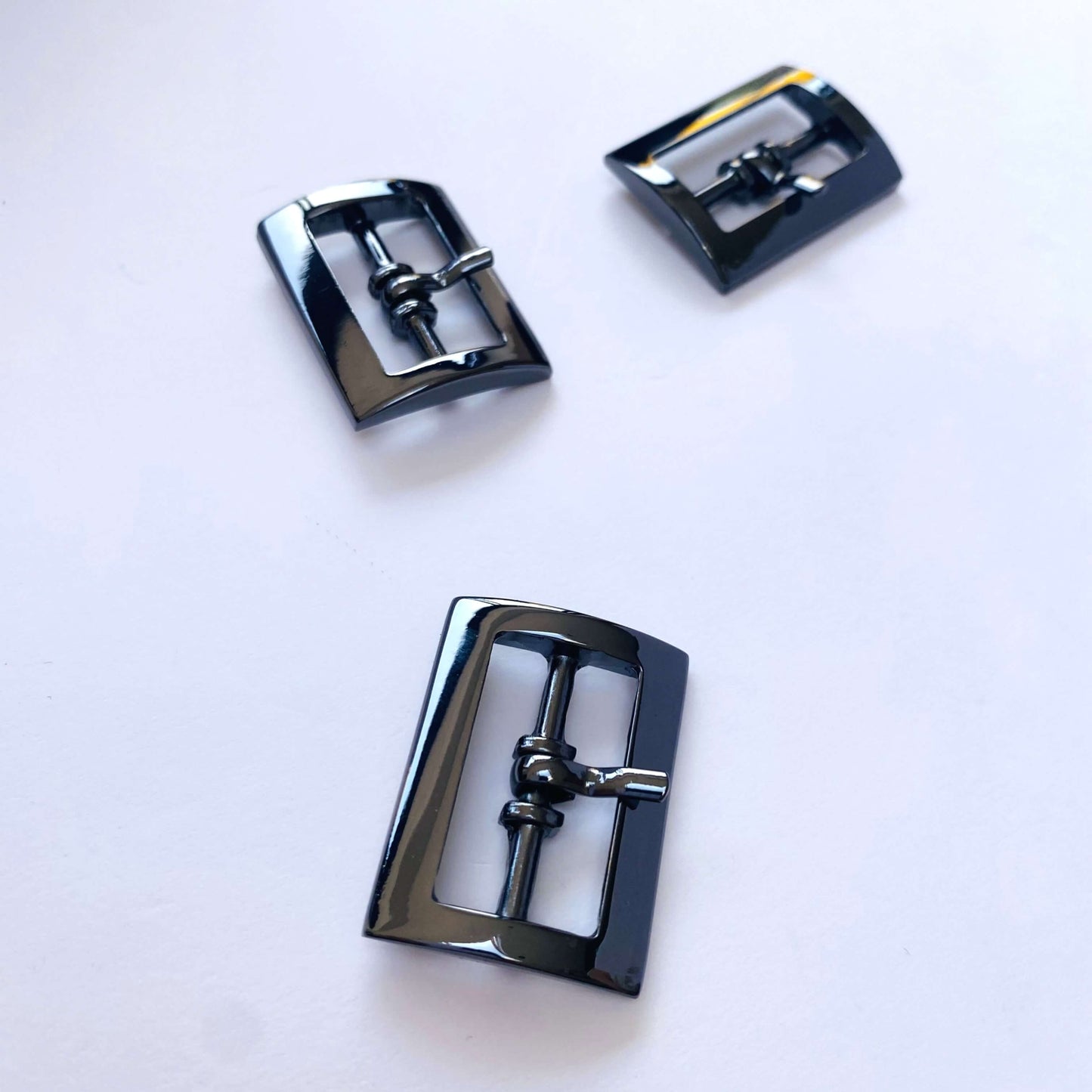 Chrome Gunmetal Rectangle Prong Buckle - 25mm -Three black metal buckles on a white background
