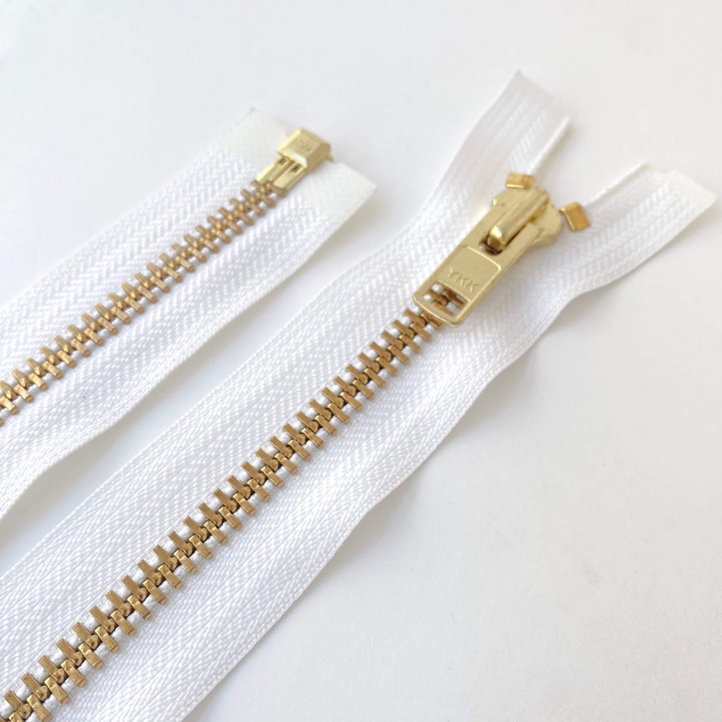 White open ended metal teeth zip