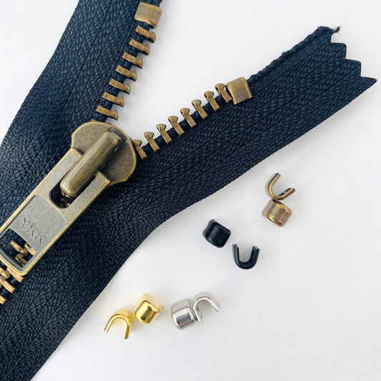 Heavy weight zipper stoppers