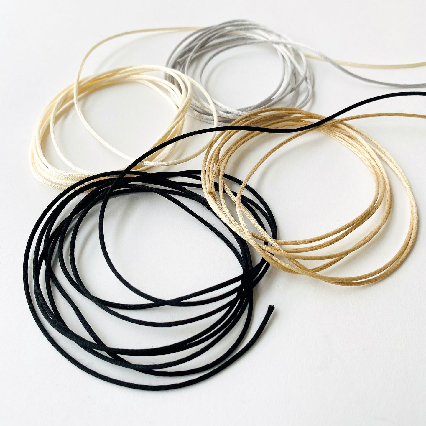 1mm Satin Rats Tail Cord in neutral shades of black, ivory, white and champagne- Kleins Haberdashery