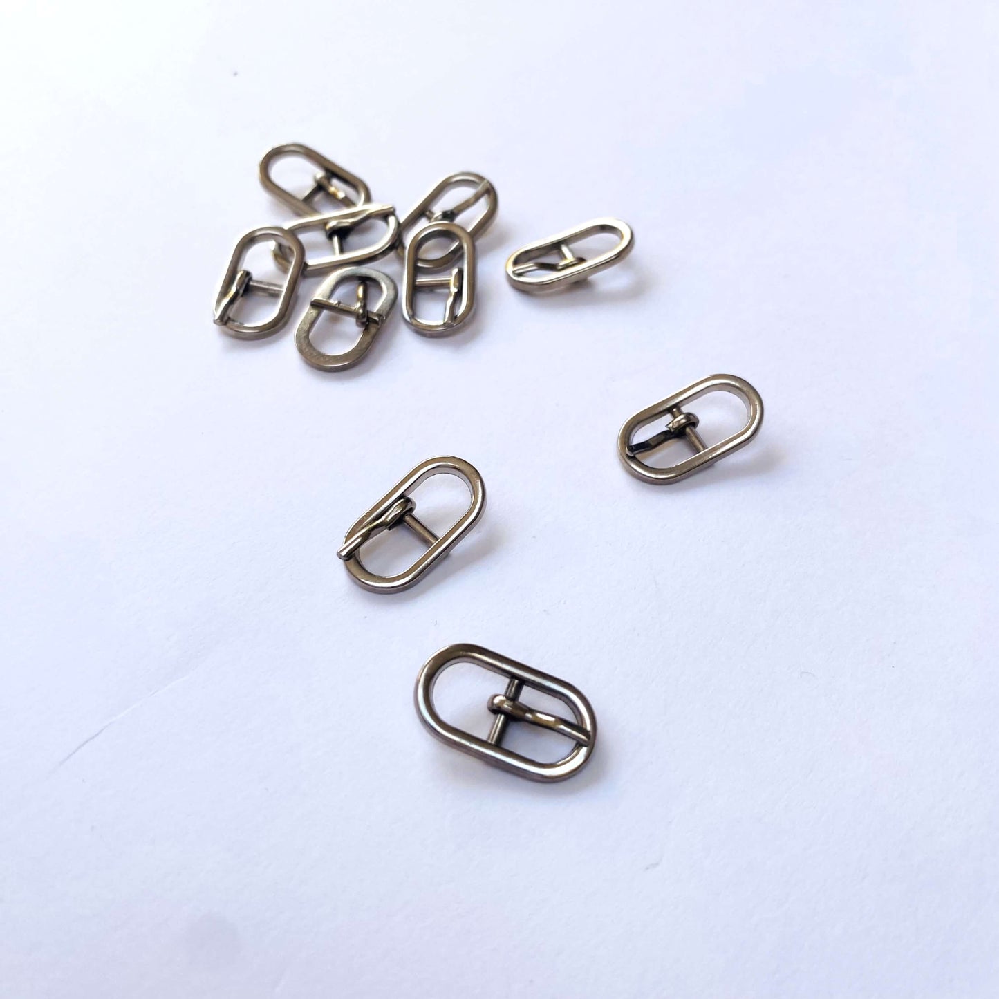 Silver Oval Prong Buckle - 6mm - Set of small metal buckles on a white background