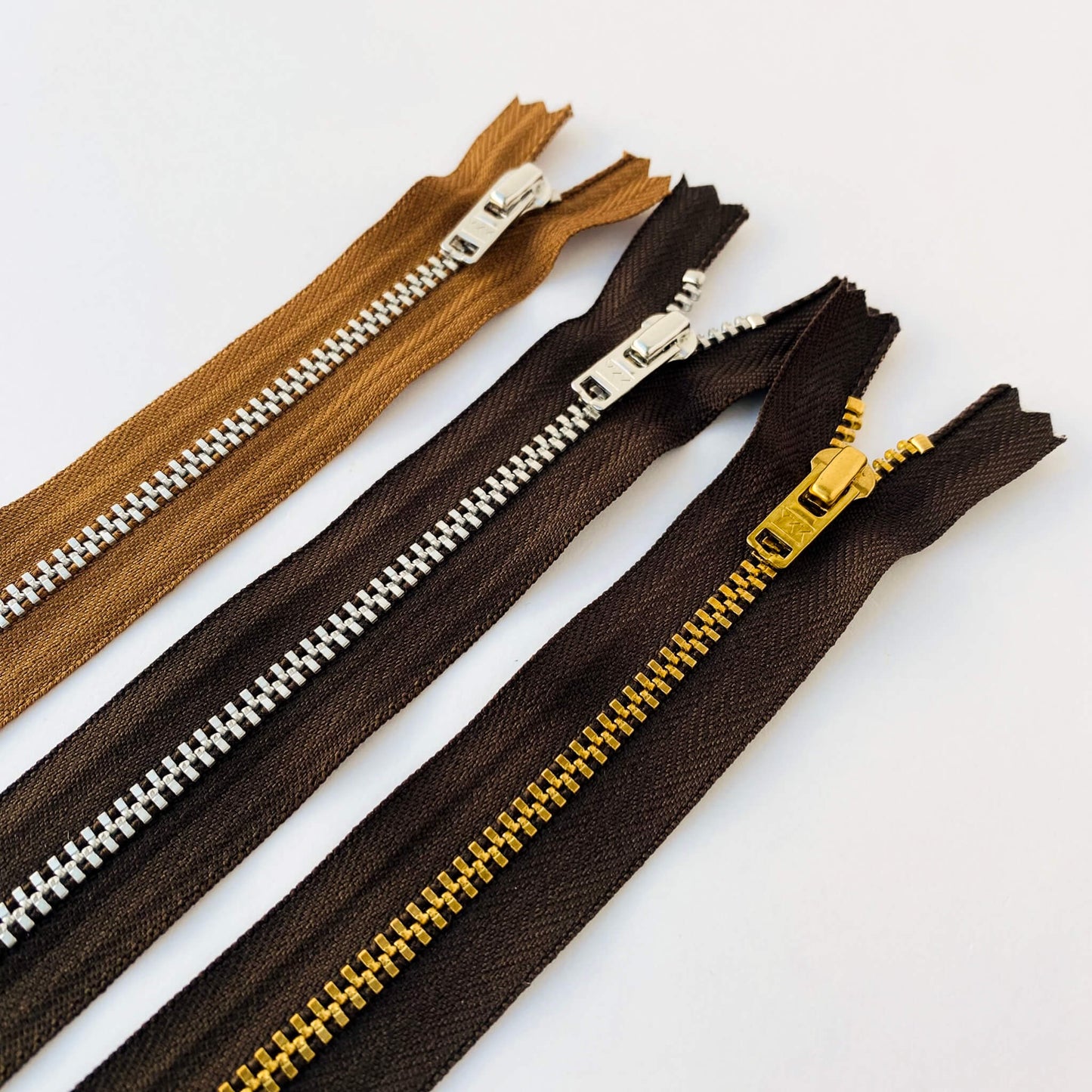 YKK jeans zip with metal teeth and auto-lock puller in various shades of brown