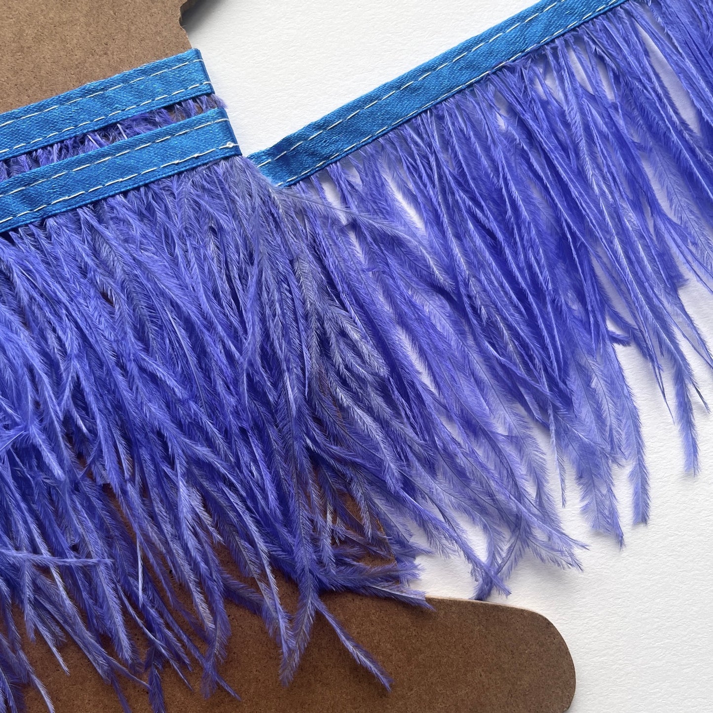 10cm deep Real ostrich feather fringe trim on a Satin ribbon for easy attachment. Would look incredible added to a jacket as a statement cuff! Ideal for dressmaking, crafts, millinery, costumes, hat making, fascinators, bridal accessories, headpieces, bags.