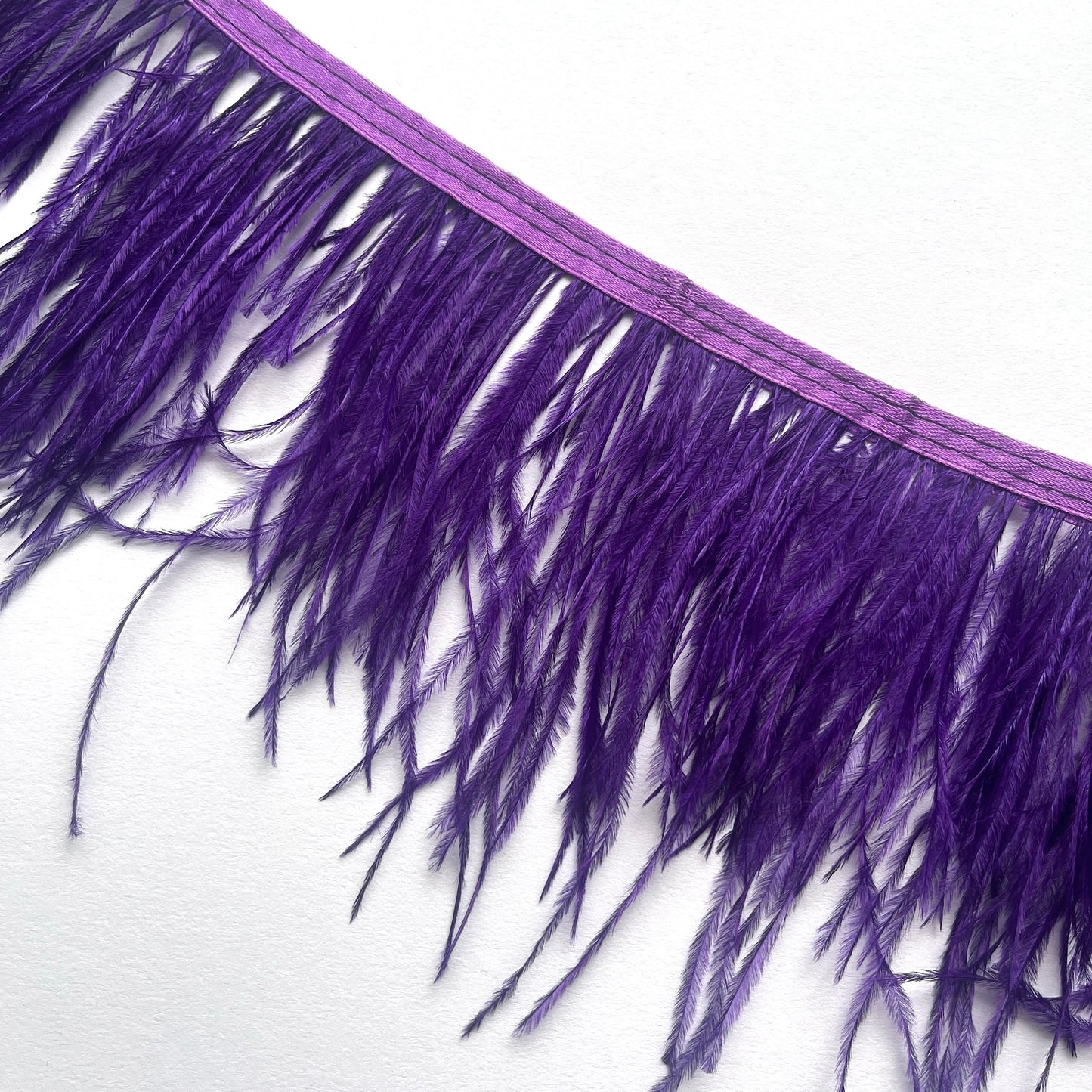 10cm deep Real ostrich feather fringe trim on a Satin ribbon for easy attachment. Would look incredible added to a jacket as a statement cuff!  Ideal for dressmaking, crafts, millinery, costumes, hat making, fascinators, bridal accessories, headpieces, bags.