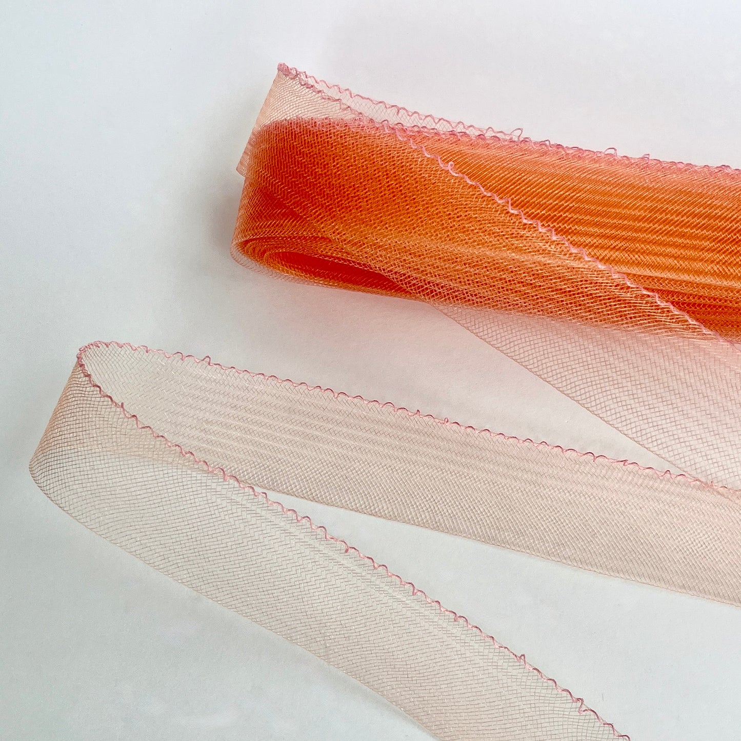 Horsehair braid, also know as crin or crinoline, threaded on one edge for easy gathering and shaping. Used to stiffen hems, giving flexible shape, support and structure where needed especially for bridal wear, evening wear, prom dresses, petticoats, theatre costumes, dance wear and often used for hat making. SOLD BY THE METRE Colours: black, peach, pink, orange, lime, turquoise, navy, purple