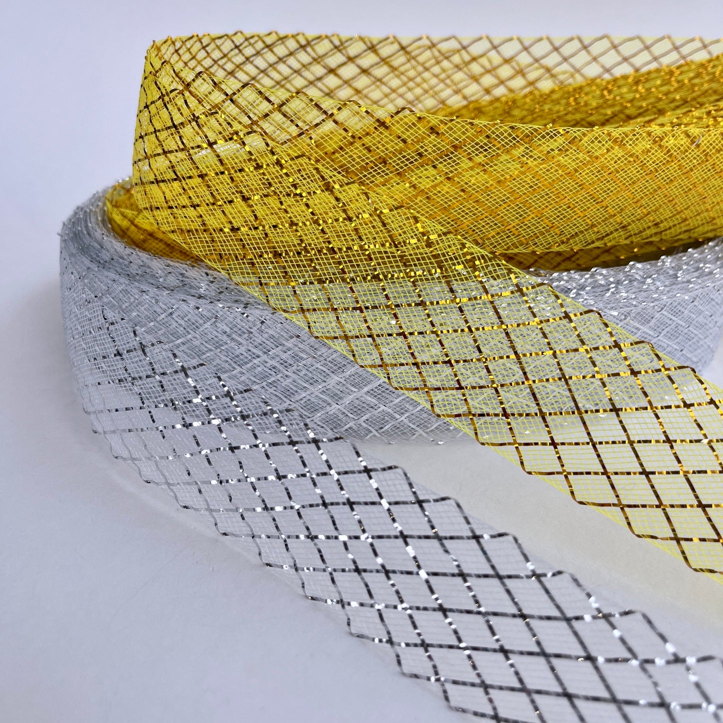 35mm lurex gold or silver Horsehair braid, also know as crin or crinoline, with lurex threads woven into a lattice pattern. Used to stiffen hems, giving flexible shape, support and structure where needed especially for bridal wear, evening wear, prom dresses, petticoats, theatre costumes, dance wear and often used for hat making.