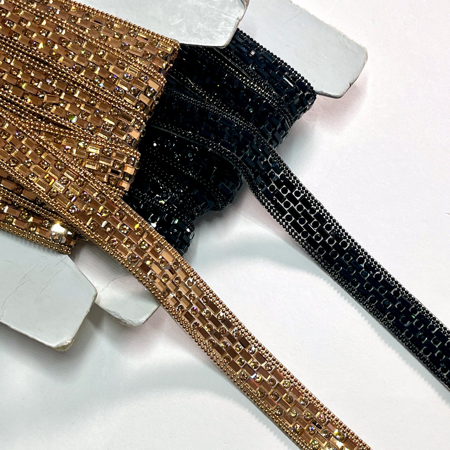 A stunning Art Deco inspired trim created with crystals and baguette shaped polished stones for sparkle, with a tiny twin bead edging. This is an iron-on embellishment with a transparent gel backing film and is very easy to cut to length.