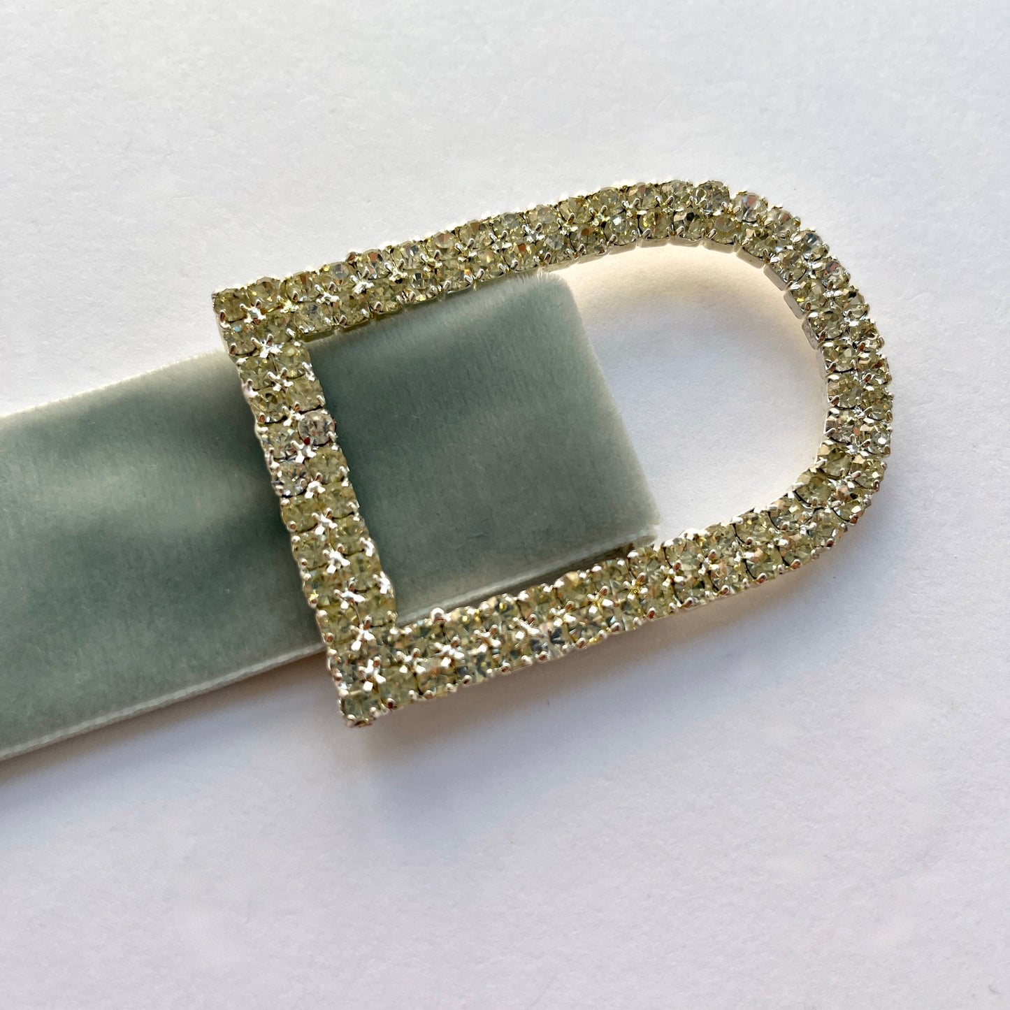 Large D shaped silver rectangle diamante buckle with a double row of rhinestones. Use as a belt buckle, an accent for straps, dressmaking projects or as an embellishment for handbags, wedding invitations, wedding favours, napkin rings and arts and craft projects.