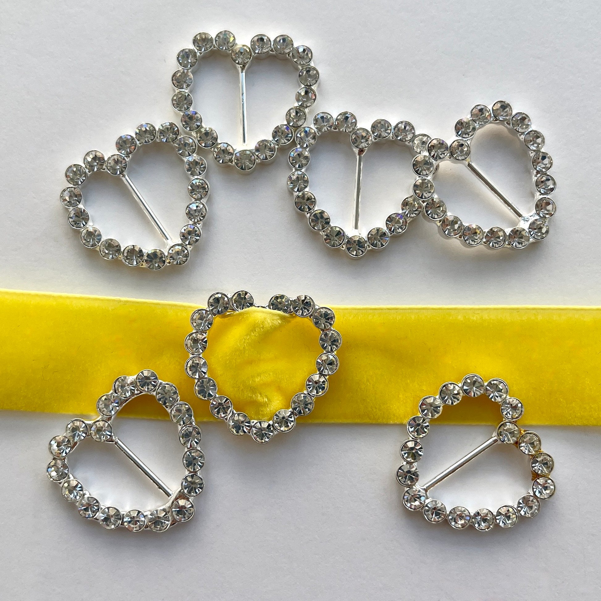 Lovely, high quality, rhinestone crystal slider buckles. Easy to use, just slide onto a ribbon or a strap to add sparkle to dress straps, bags. Perfect for a spot of DIY to embellish wedding invitations, wedding favours, napkin rings and arts and craft projects. Shown on 1cm (⅜”) wide velvet ribbon.