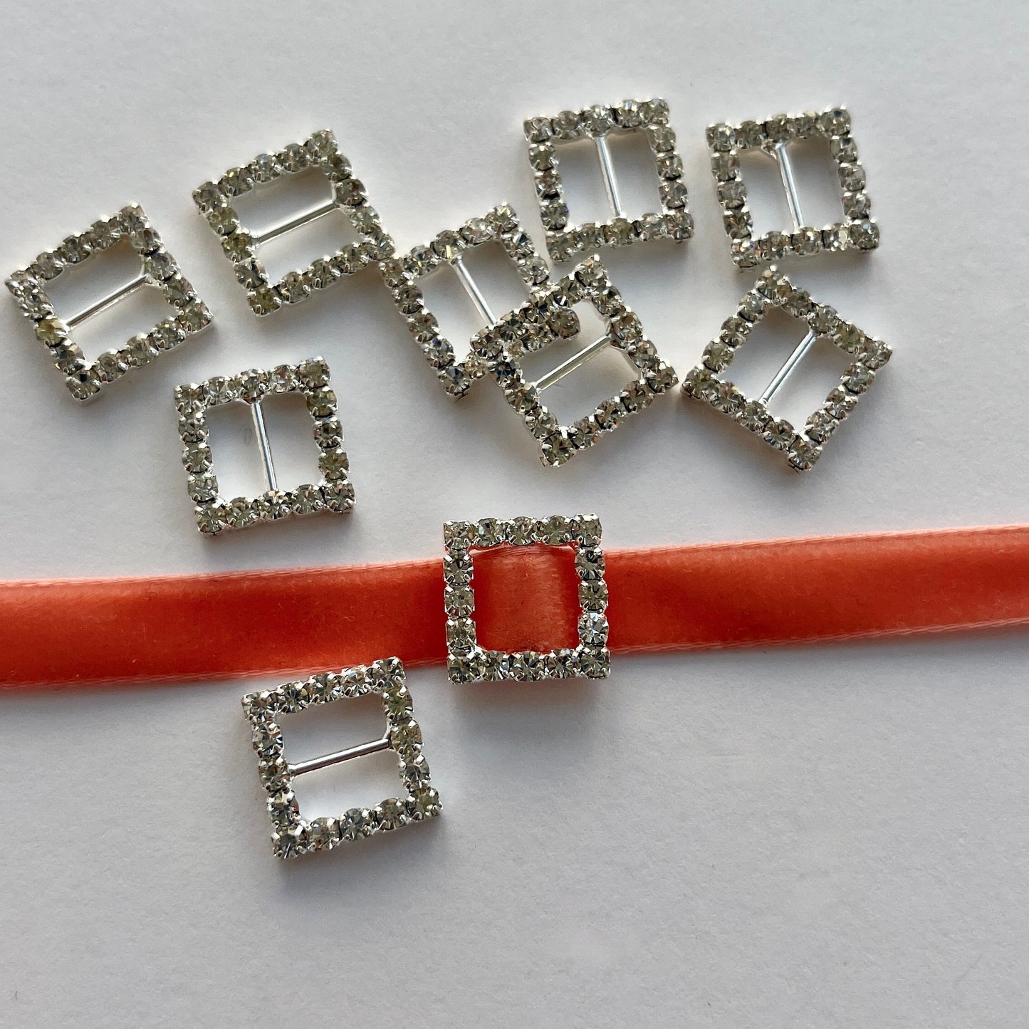 SQUARE DIAMANTE SLIDER BUCKLE - Lovely, high quality, rhinestone crystal slider buckles. Easy to use, just slide onto a ribbon or a strap to add sparkle to dress straps, bags. Perfect for a spot of DIY to embellish wedding invitations, wedding favours, napkin rings and arts and craft projects. Shown on 1cm (⅜”) wide velvet ribbon.