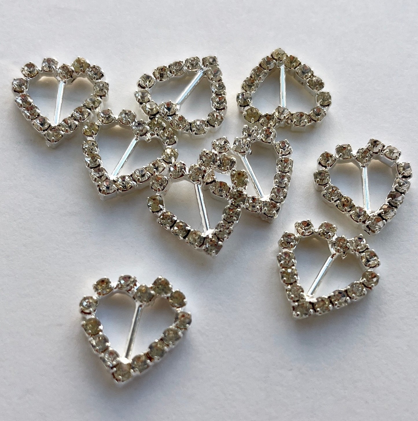Lovely, high quality, rhinestone crystal slider buckles. Easy to use, just slide onto a ribbon or a strap to add sparkle to dress straps, bags. Perfect for a spot of DIY to embellish wedding invitations, wedding favours, napkin rings and arts and craft projects. Shown on 1cm (⅜”) wide velvet ribbon.