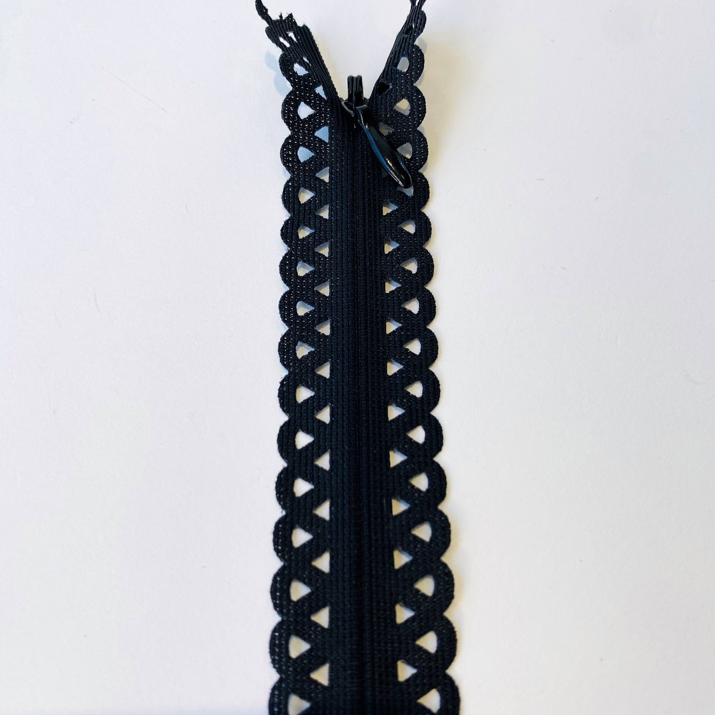 Lace Edged Invisible, Concealed zippers - 70cm long fancy dress zips, lightweight black invisible zips with geometric cut out tape, scalloped edge fancy zip tape