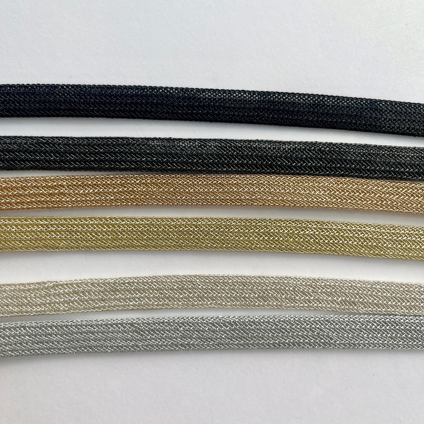 Beautiful and supple, this metallic plaited braiding has a clear plastic strip inside for extra strength and durability making it ideal for many applications including dress or bag staps. The internal plastic strip may be removed if desired