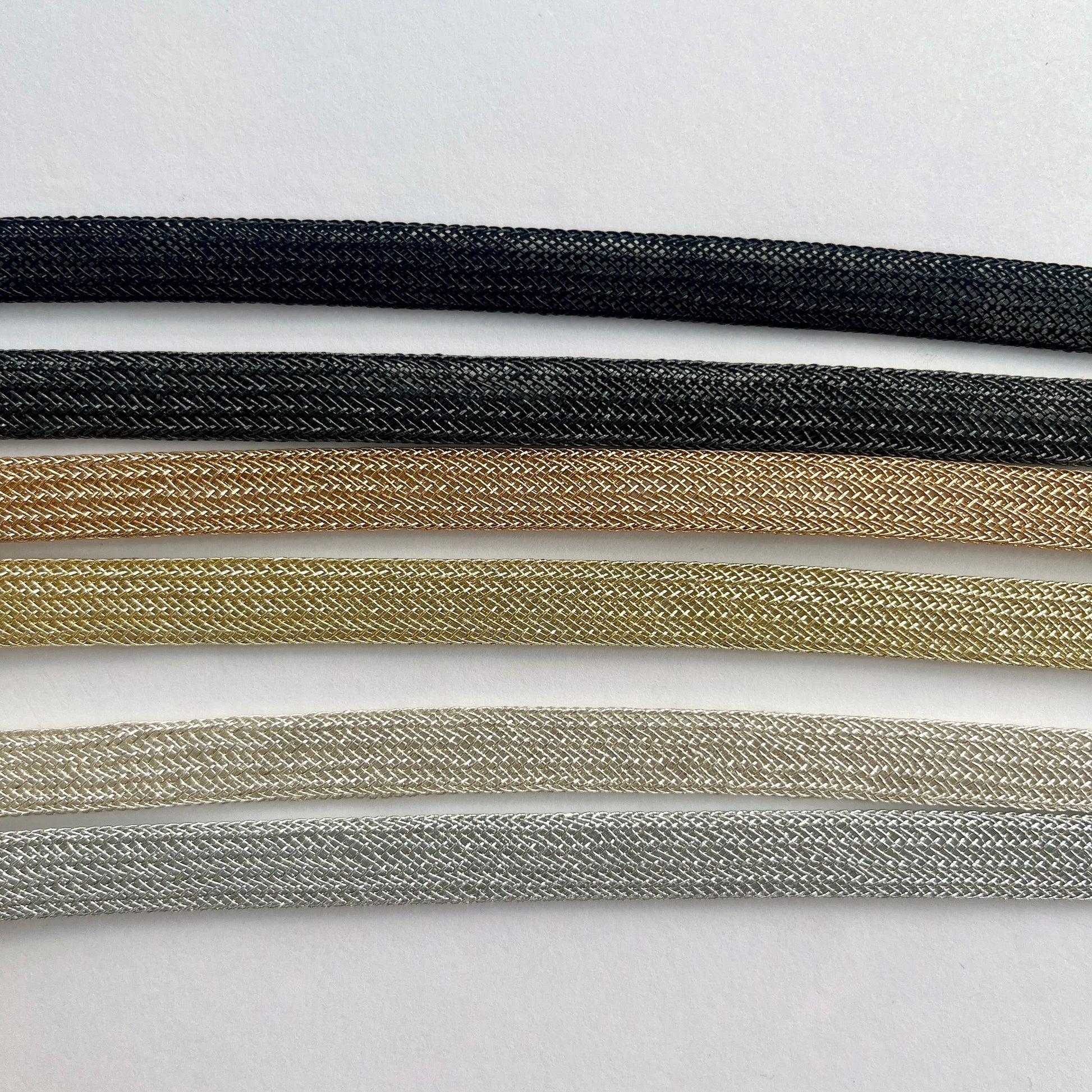 Beautiful and supple, this metallic plaited braiding has a clear plastic strip inside for extra strength and durability making it ideal for many applications including dress or bag staps. The internal plastic strip may be removed if desired