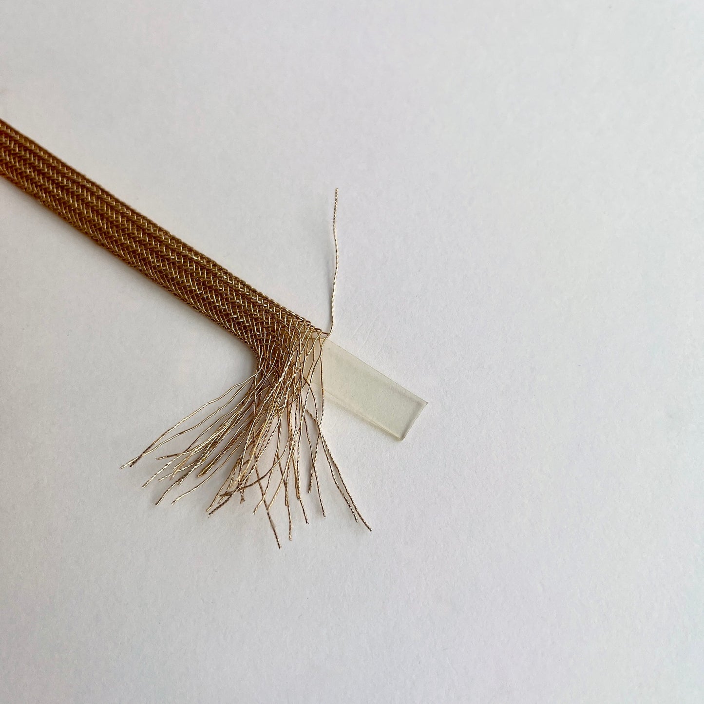 Beautiful and supple, this metallic plaited braiding has a clear plastic strip inside for extra strength and durability making it ideal for many applications including dress or bag staps. The internal plastic strip may be removed if desired