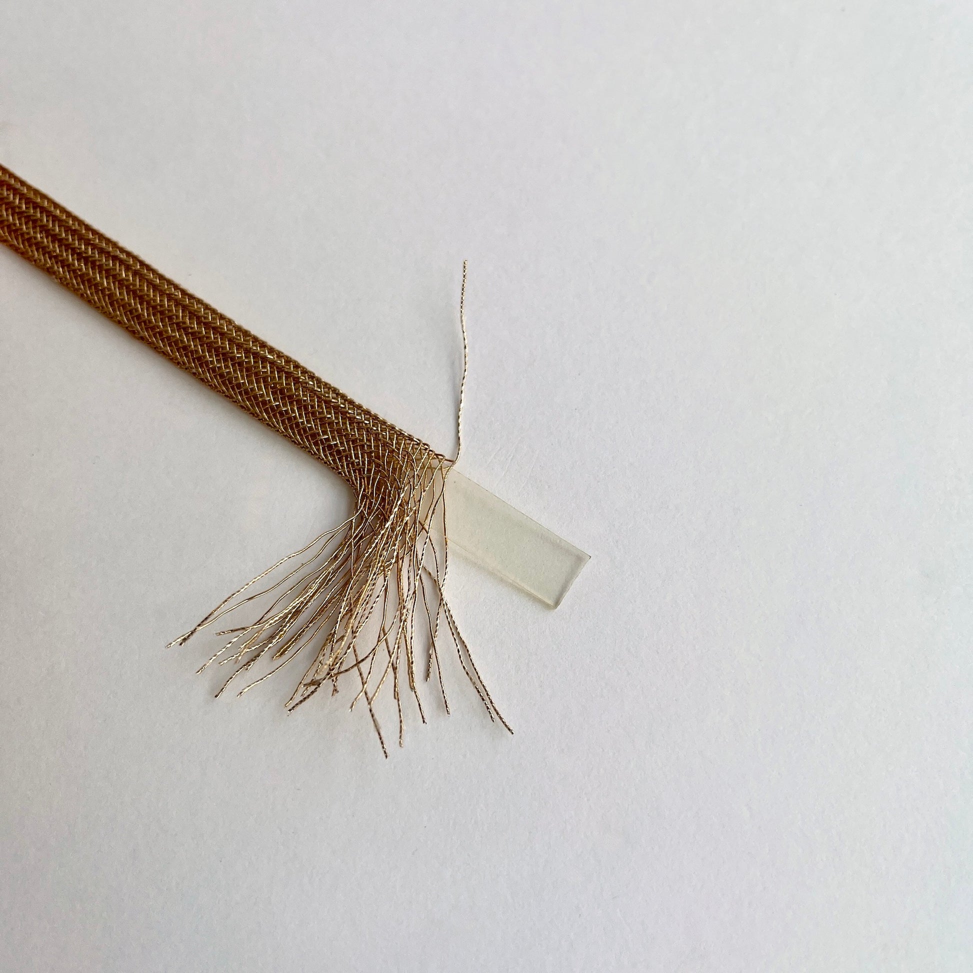 Beautiful and supple, this metallic plaited braiding has a clear plastic strip inside for extra strength and durability making it ideal for many applications including dress or bag staps. The internal plastic strip may be removed if desired