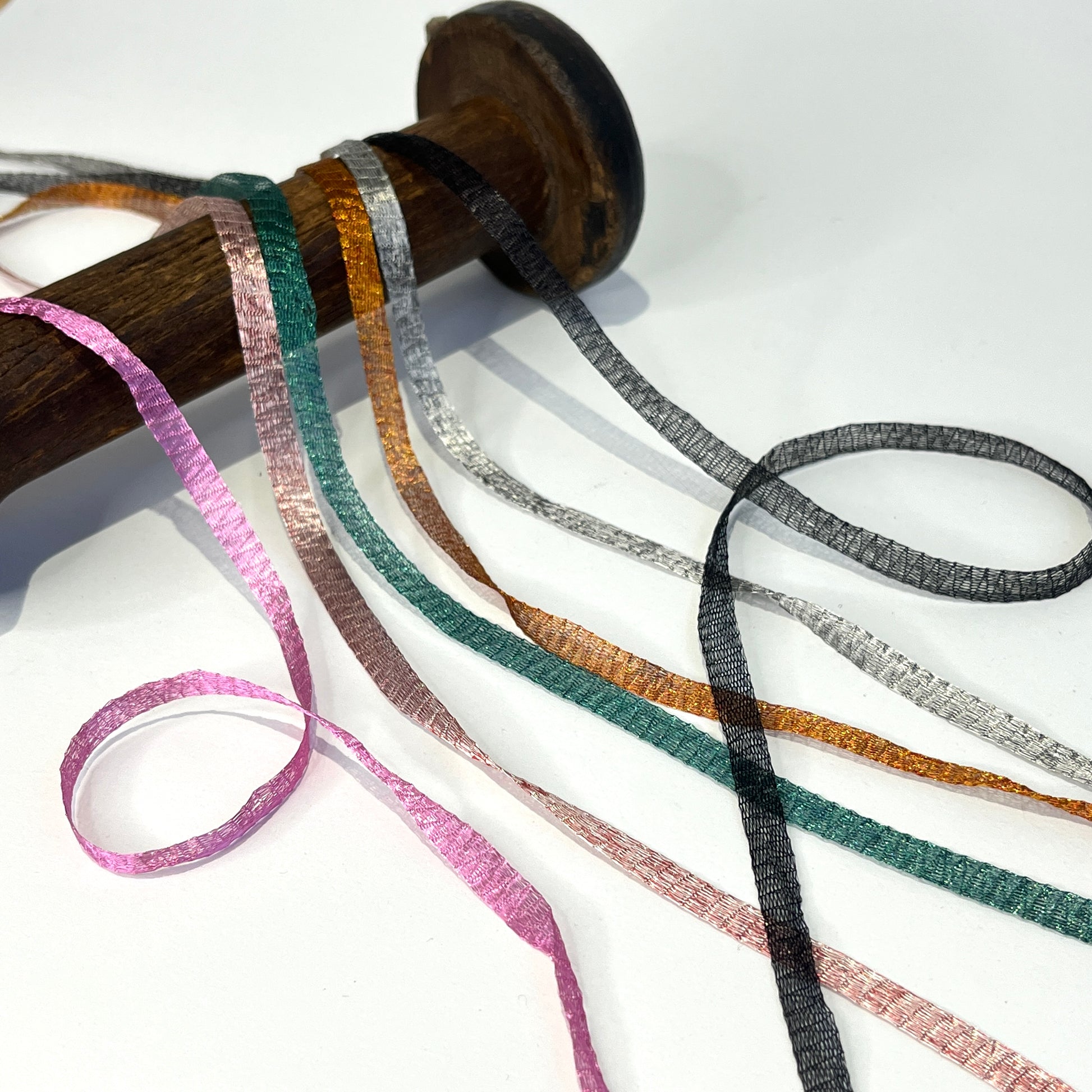 Metallic Woven Tubular Braid  Knitted metallic mesh trim that could be used for straps or used for jewellery creations. Tthe trim can be pulled from either side to create unique shaped contortions.