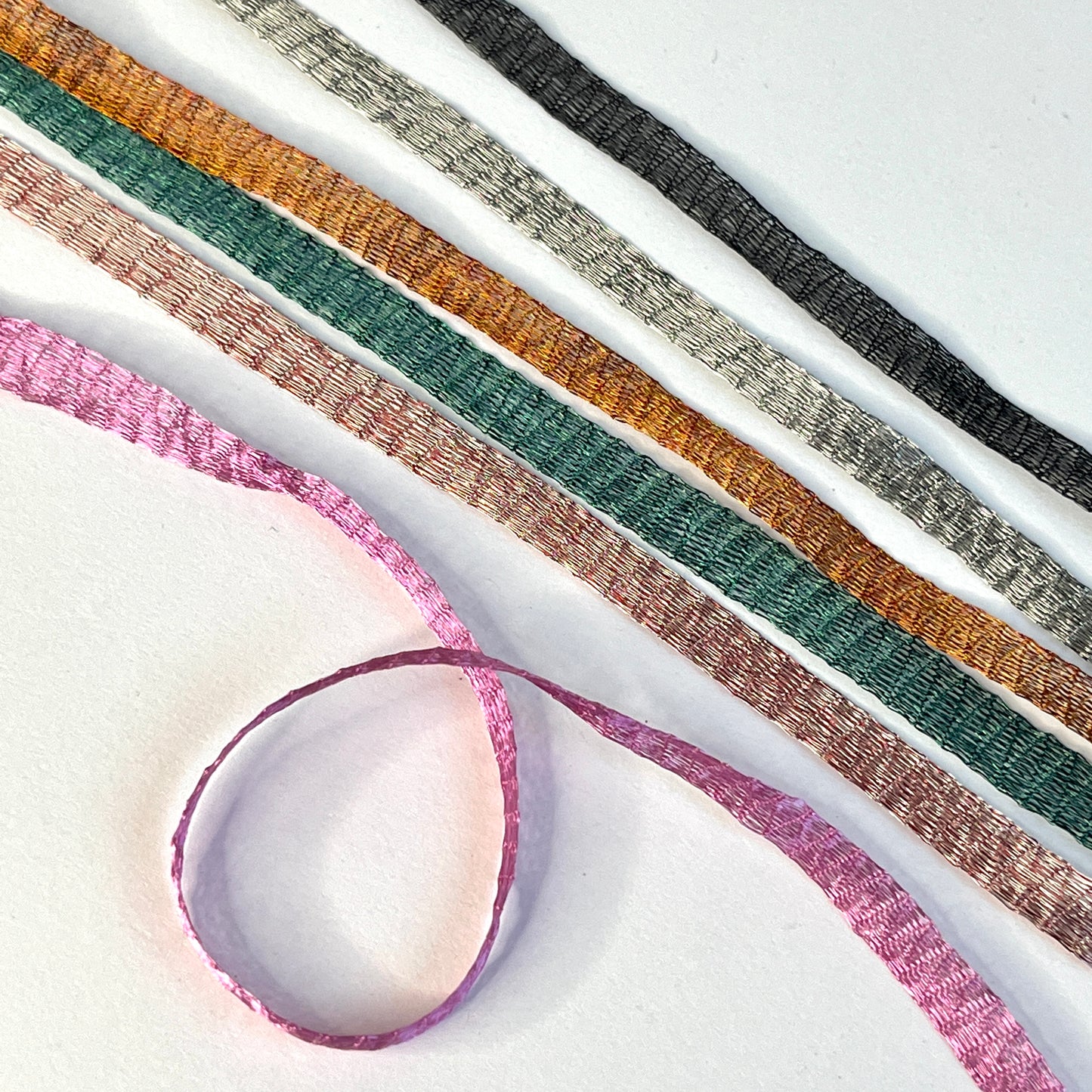 Metallic Woven Tubular Braid  Knitted metallic mesh trim that could be used for straps or used for jewellery creations. Tthe trim can be pulled from either side to create unique shaped contortions.