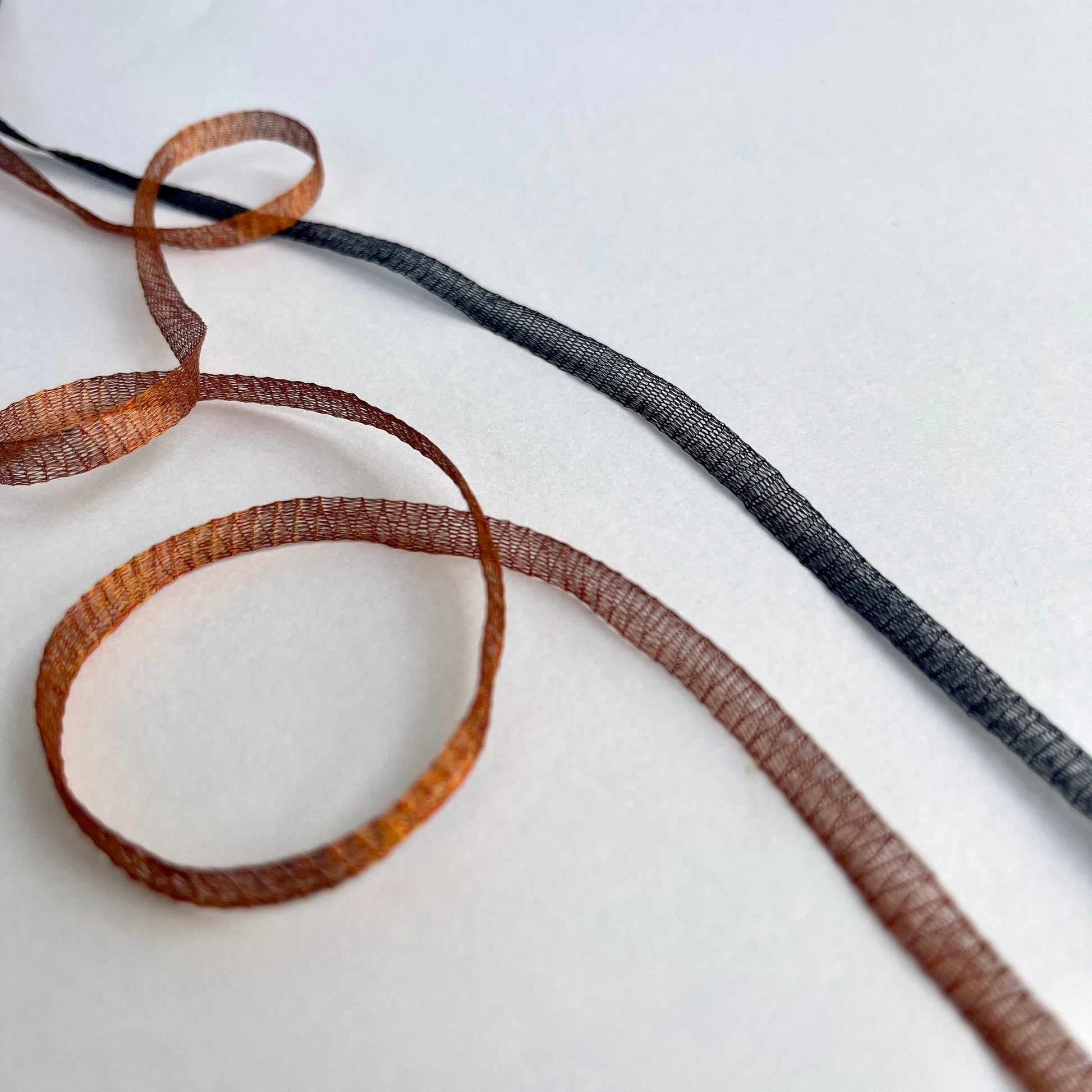 Metallic Woven Tubular Braid  Knitted metallic mesh trim that could be used for straps or used for jewellery creations. Tthe trim can be pulled from either side to create unique shaped contortions.