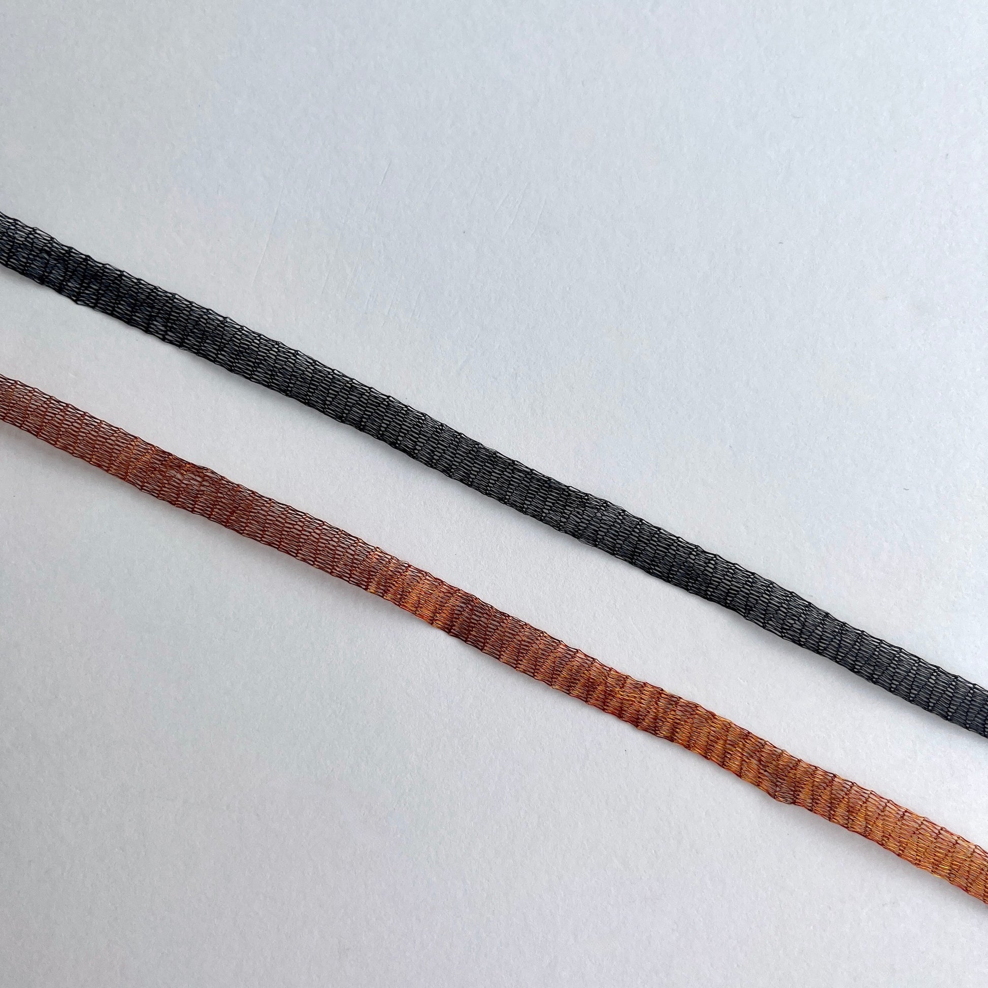 Metallic Woven Tubular Braid  Knitted metallic mesh trim that could be used for straps or used for jewellery creations. Tthe trim can be pulled from either side to create unique shaped contortions.