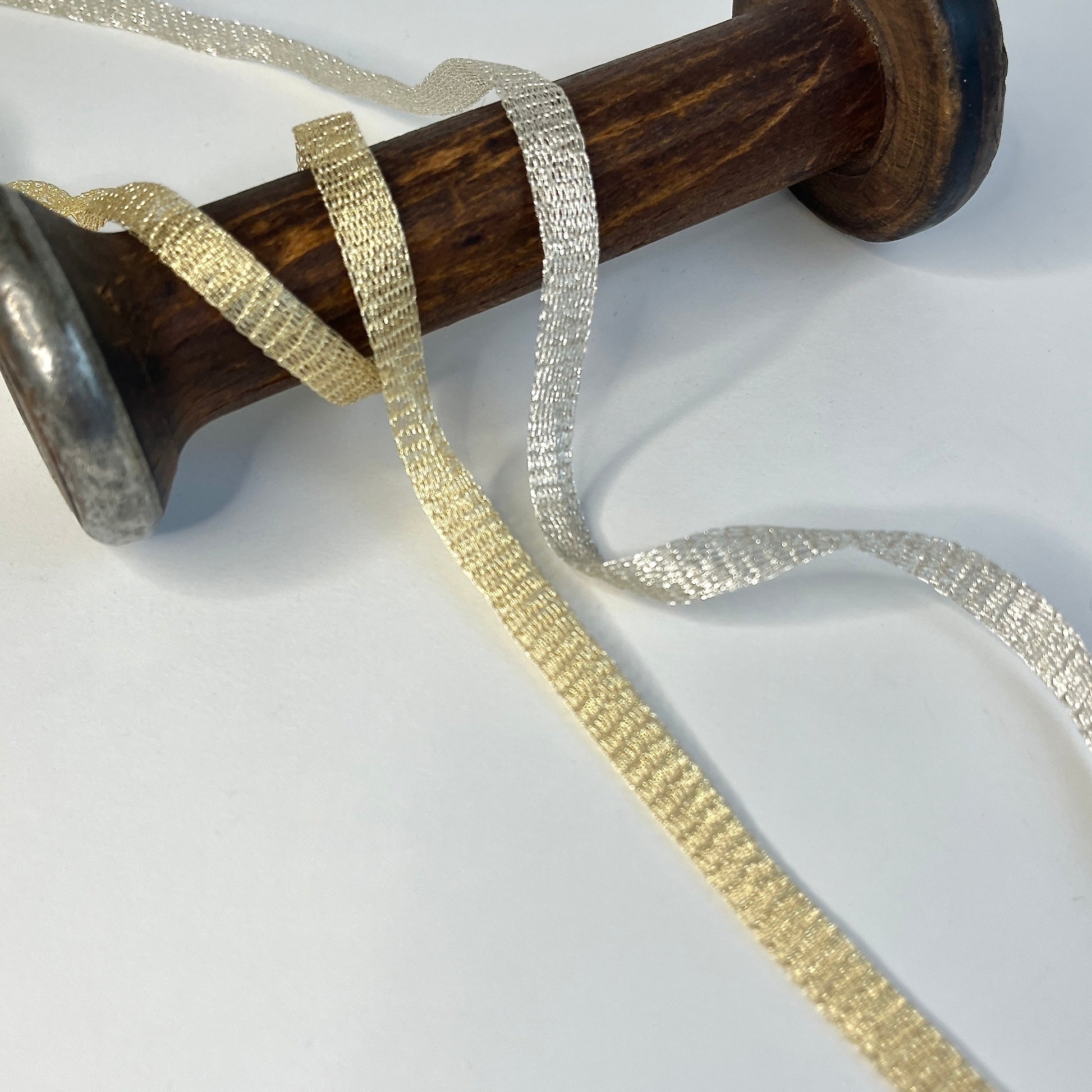 Italian Mesh wire ribbon trimming by Menoni  Knitted metallic tubular mesh trim that could be used for straps or used for jewellery creations. The trim can easily be pulled from either side to create unique shaped contortions for floral arranging, jewellery making and beading.