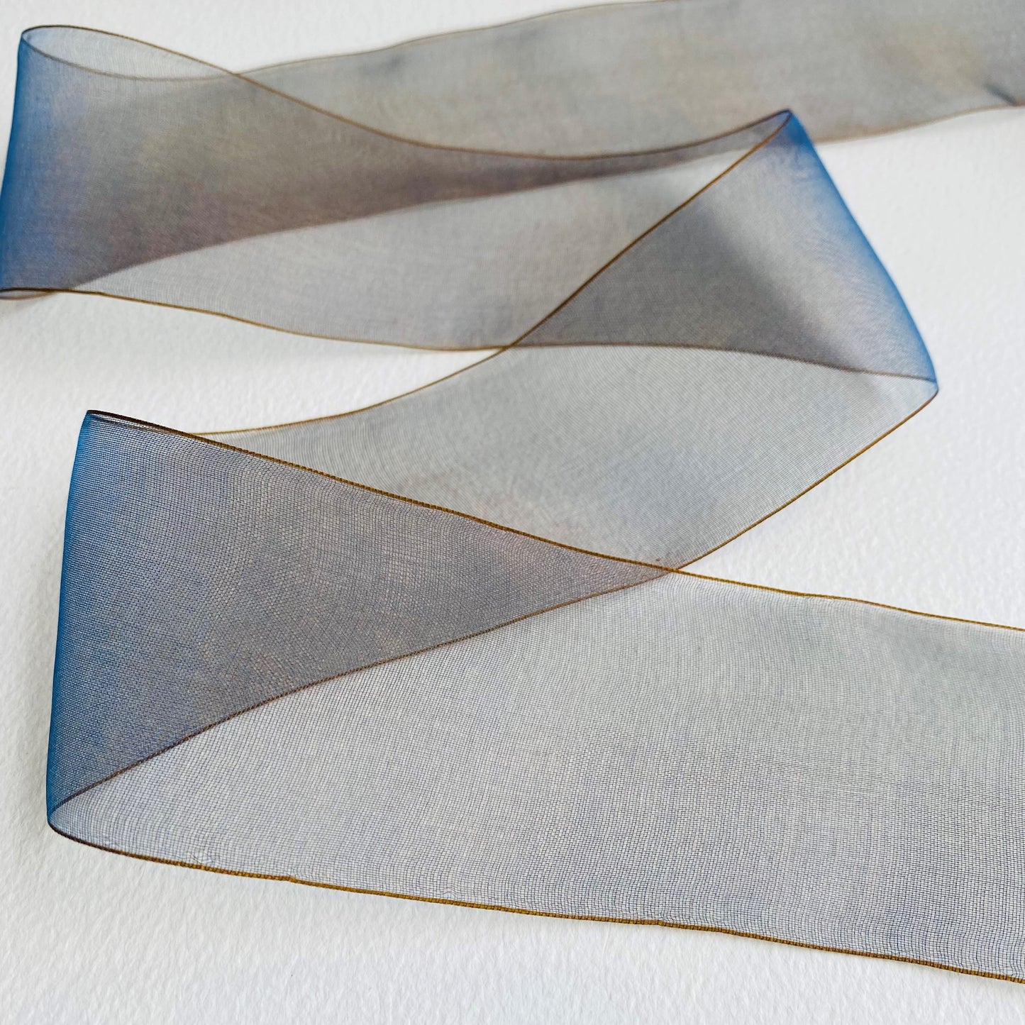 50mm Chiffon ribbon by MOKUBA A luxurious soft sheer chiffon ribbon trim by Mokuba, which comes in 6 beautiful colours. Col: Gold 01, Blue 02, Navy 09, Grey 15, Blush 16, and Red 23.