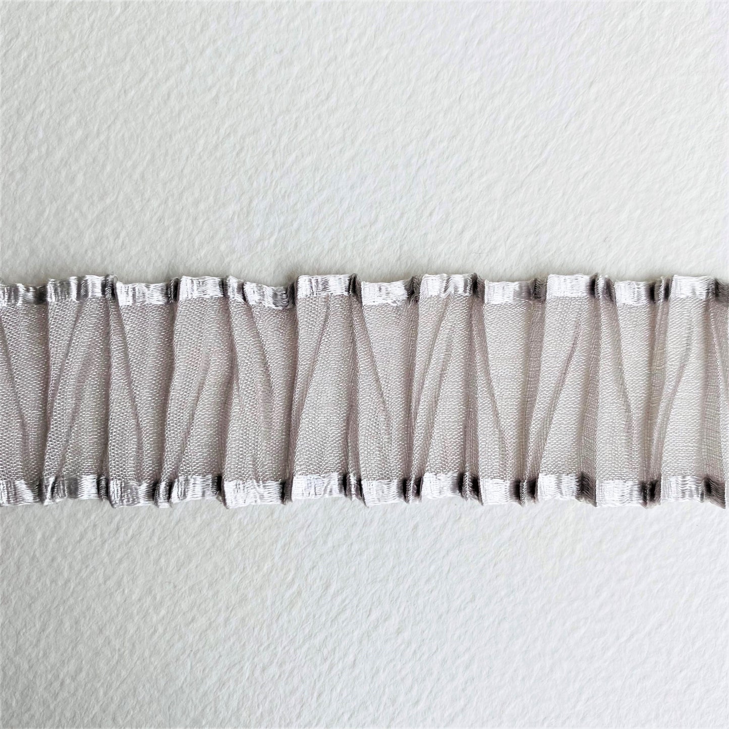 25mm Pleated Organza ribbon by MOKUBA A beautifully soft pleated Organza Sheer ribbon trim by Mokuba, carefully gathered, which comes in two delightful colours. Col: Grey 05 and Gold 12