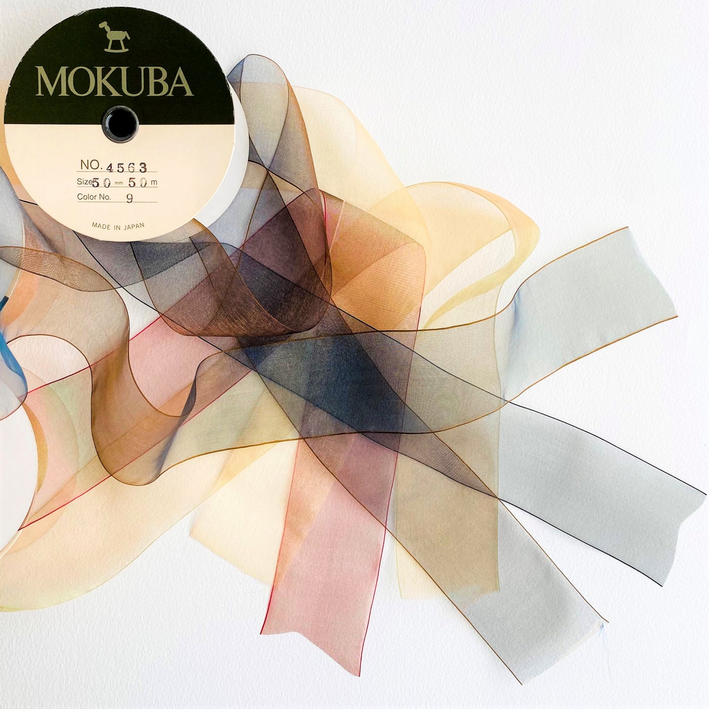 50mm Chiffon ribbon by MOKUBA A luxurious soft sheer chiffon ribbon trim by Mokuba, which comes in 6 beautiful colours. Col: Gold 01, Blue 02, Navy 09, Grey 15, Blush 16, and Red 23.