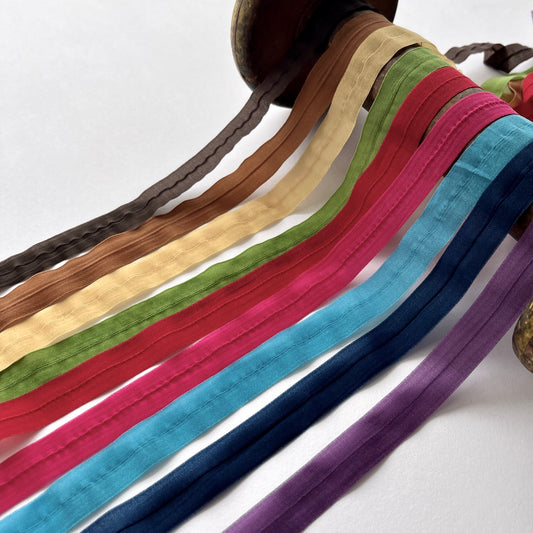 A beautiful sheer chiffon fold-over stretch binding. 16mm wide with a centre fold. Use as a binding for necklines and armholes on stretch fabrics, for straps, lingerie and underwear making, headbands, hair ties, dancewear and active wear projects.