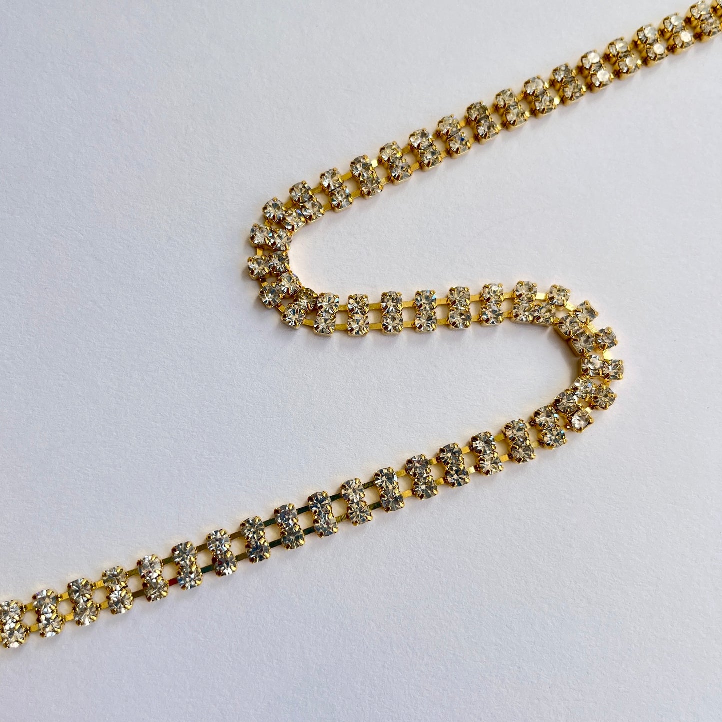 Unusual 2 row sparkly rhinestone trim - premium high grade diamanté crystals set in a flexible metal chain casing. Popular for bridal wear, evening wear, crafts, jewellery and headband making.