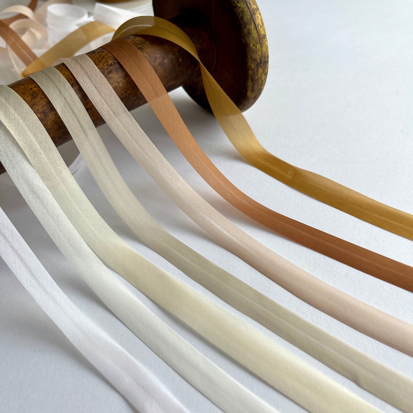 A beautiful silk organza, double folded, bias binding used to finish the edges of sheer and fine fabrics. Perfect for bridal wear, lingerie and bra making in tones of nude