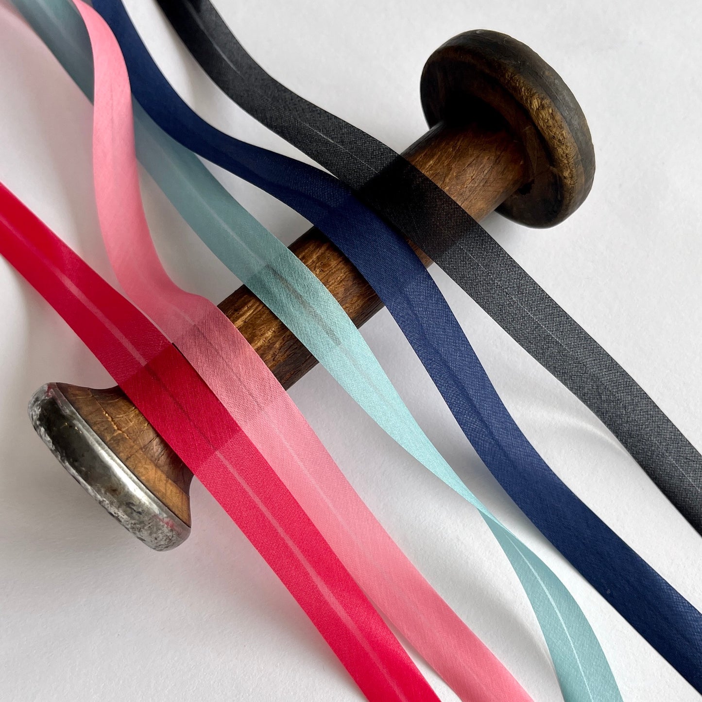A beautiful silk organza, double folded, bias binding used to finish the edges of sheer and fine fabrics. Perfect for bridal wear, lingerie and bra making. Red bias, pink bias binding, black bias binding, navy bias binding , turquoise binding