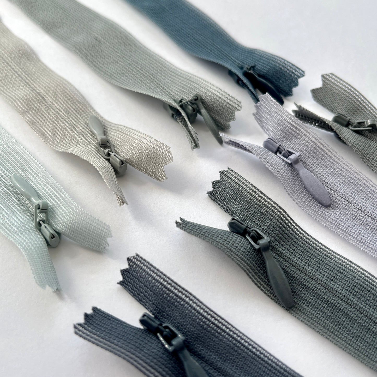 YKK Lightweight Invisible zip in grey shades - 66cm (26") length, Lightweight invisible, concealed zip with closed-end for dressmaking.