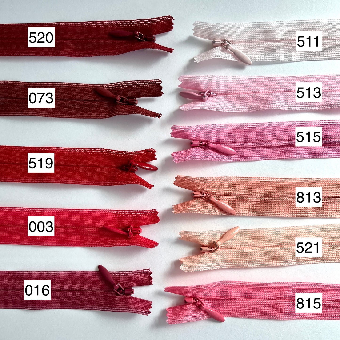 YKK Lightweight Invisible zip in red and pink shades - 66cm (26") length, Lightweight invisible, concealed zip with closed-end for dressmaking.