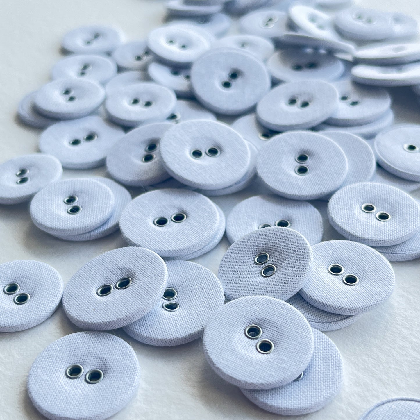 Lovely utilitarian, vintage style linen covered buttons. Flat with 2 holes and fabric on both sides of the button. Price is for 10 buttons Colour: white Sizes: 26 Ligne (16mm), 28 Ligne (18mm), 30 Ligne (19mm)