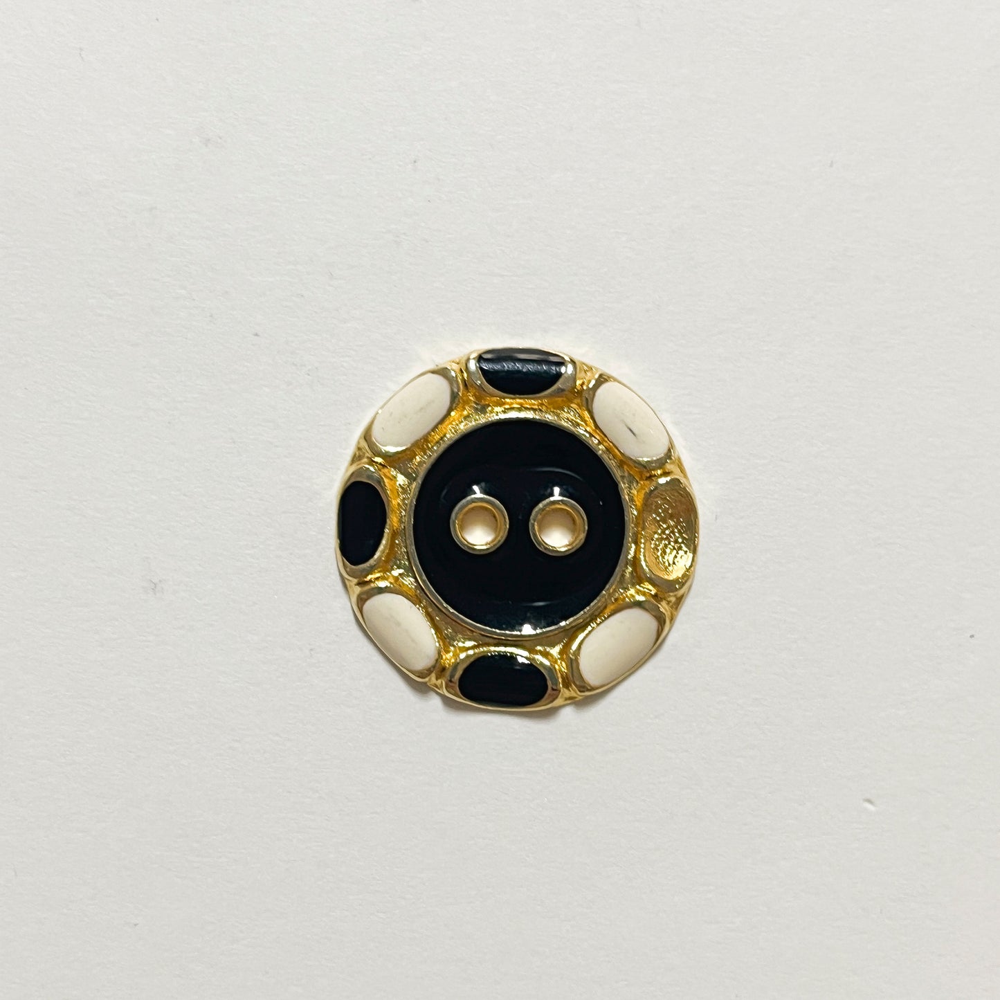 Set of 11 beautiful enamelled buttons from the 1980s. Flat with 2 holes and navy and ivory enamel work. In excellent condition but please note 1 of the large buttons has one spot of enamel missing