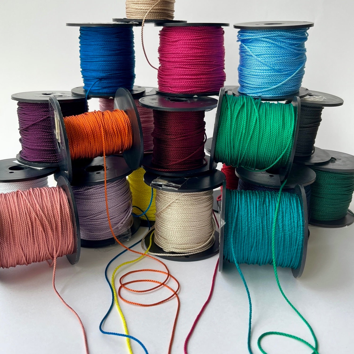 1.5mm Rayon Silky Twisted Cord - 23 beautiful colours of silky rayon cord stacked in a pile