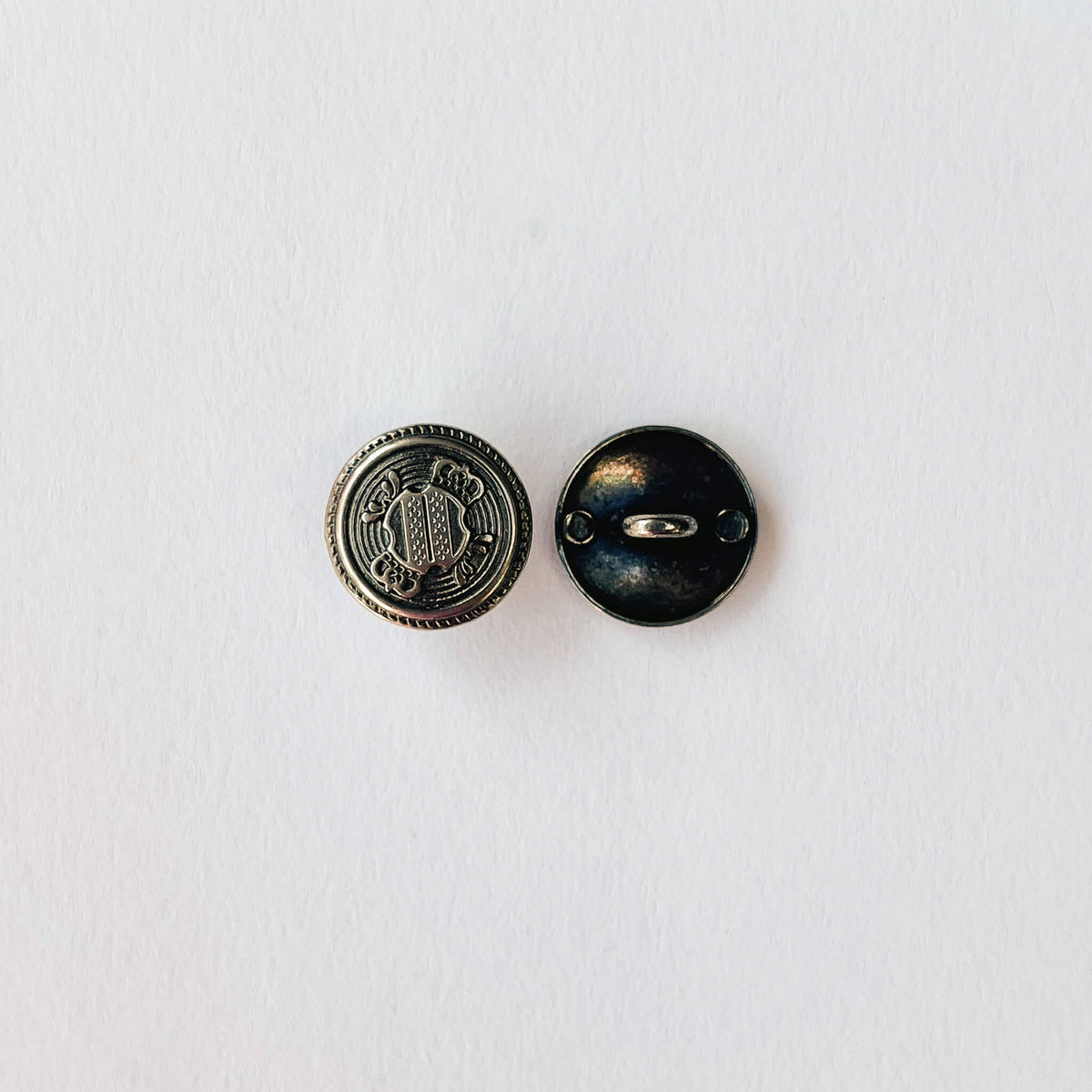 close up of 15mm Crested Military Shank Buttons in Antique silver