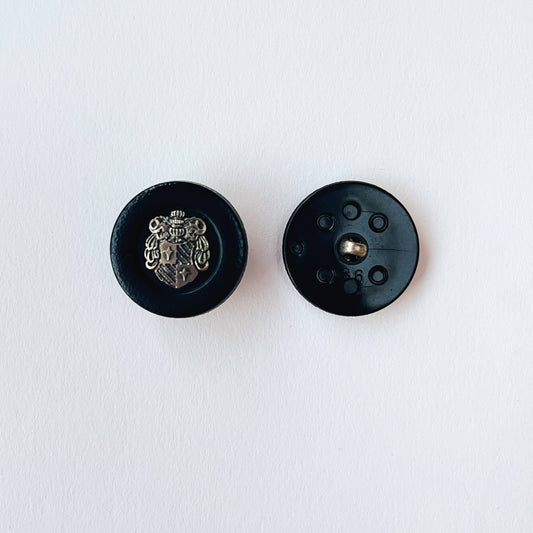 close up of 36 line, 23mm Crested Military Button with heraldic  Coat of Arms Shield design on white background