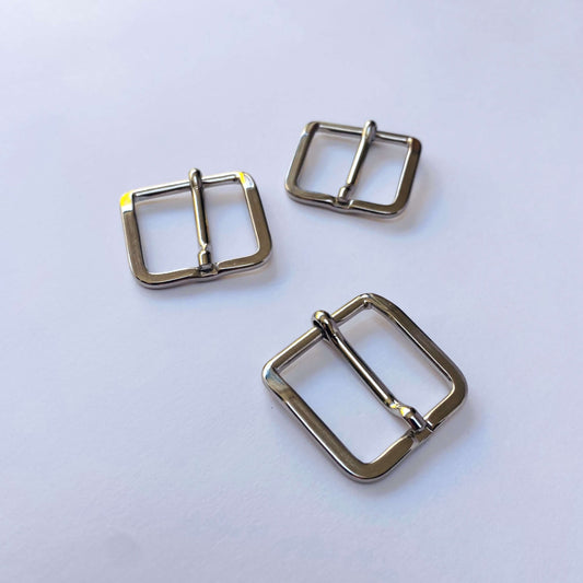 Three silver metal square prong buckles