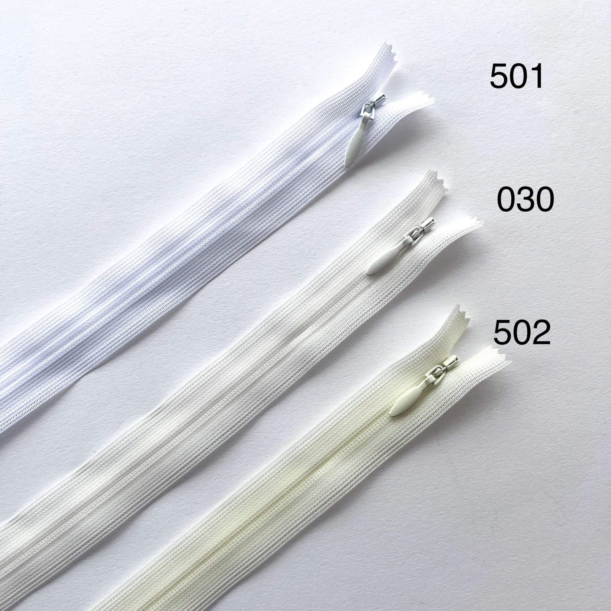 Three zippers labeled 501, 030, and 502 on a white background