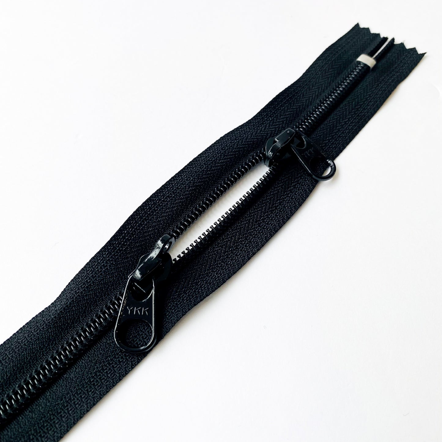 Black YKK head to head coil bag zip with lockable pullers