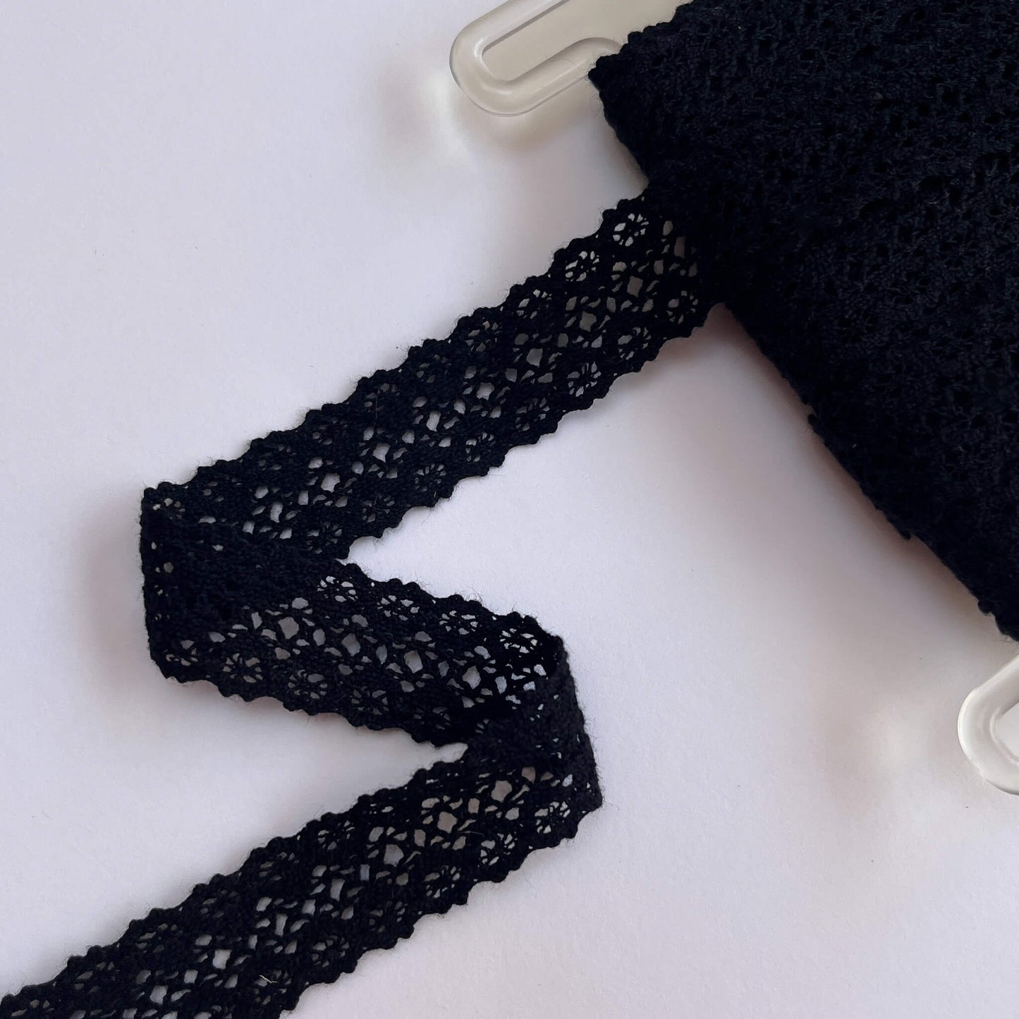 Black lace trim on a white background