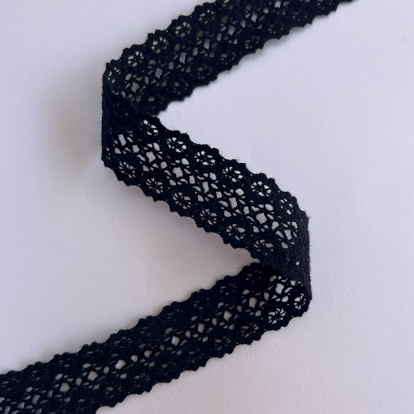 Black lace trim on a white background