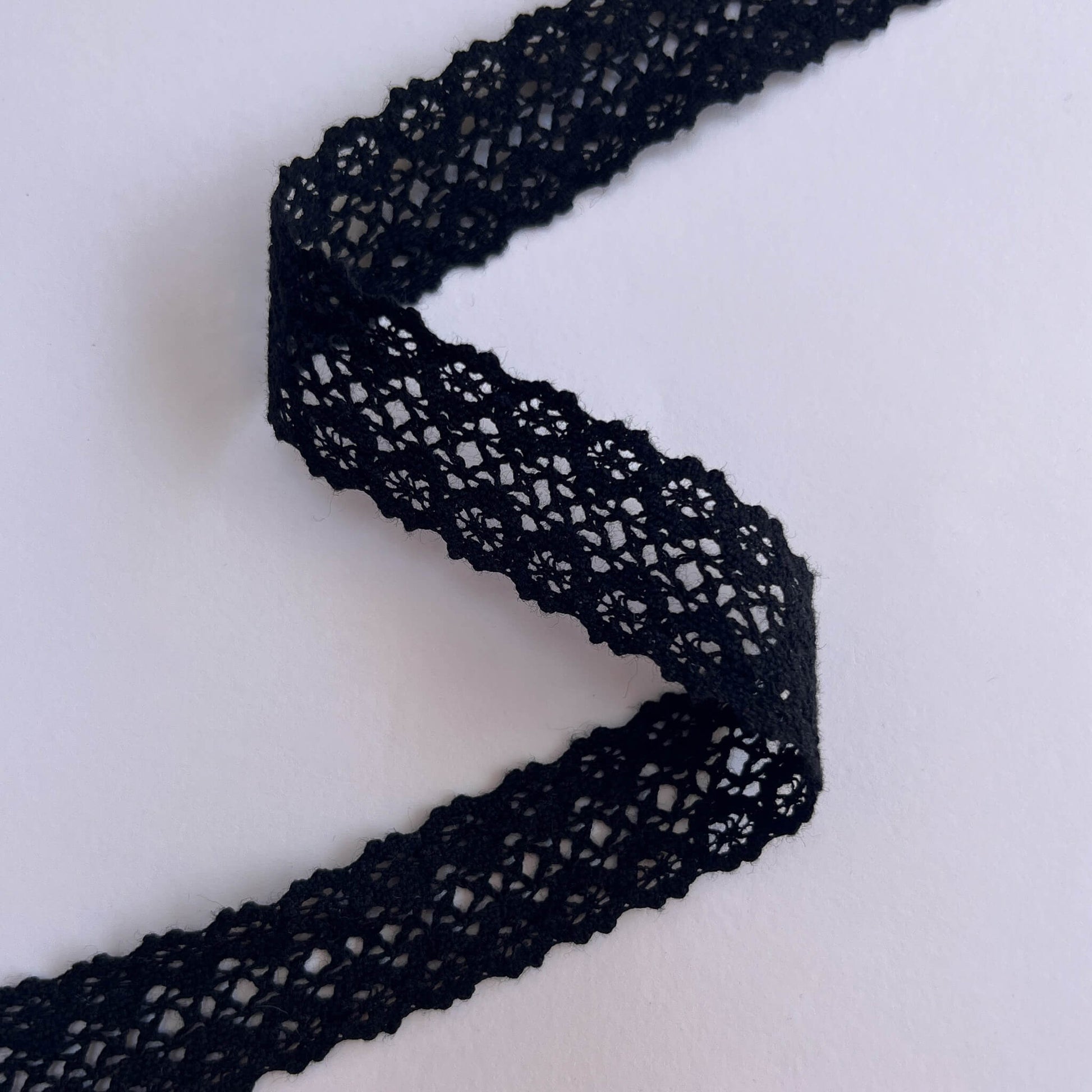 Black lace trim on a white background