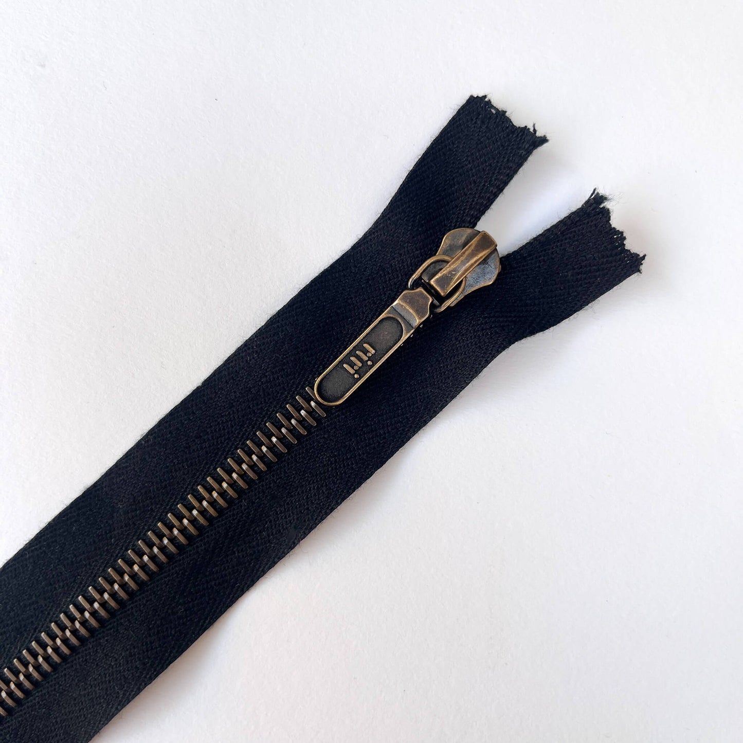 close up of RiRi Zip by RiRi with antique brass metal teeth and lozenge puller - Kleins Haberdashery